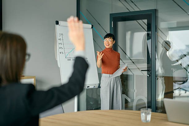 istock Business woman presenting chart and employee asking question 2248944882