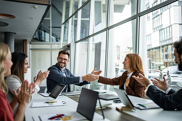 istock Business people shaking hands celebrating successful deal 2248944984