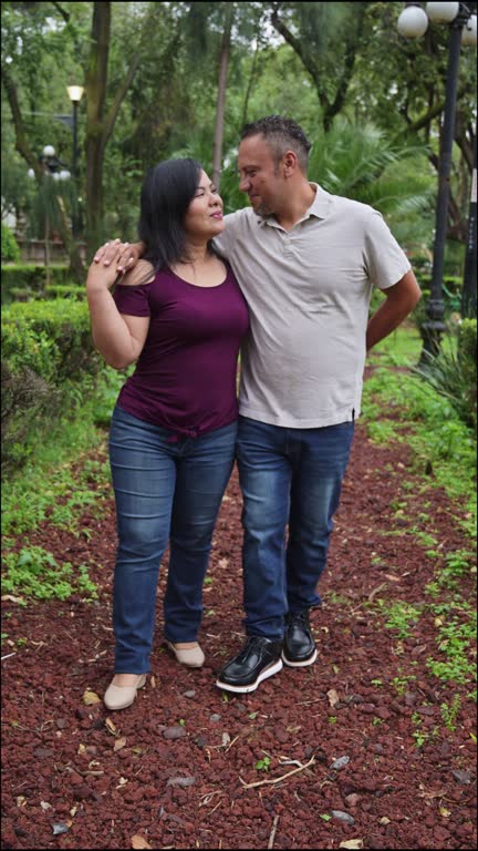 Couple Enjoying a Peaceful Walk and Tender Hugs in a CDMX Park Post-Rain