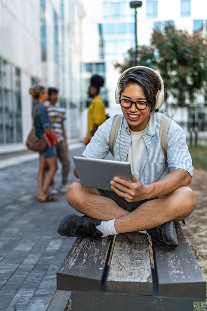 istock Young adult student watching online content on tablet 2248947056