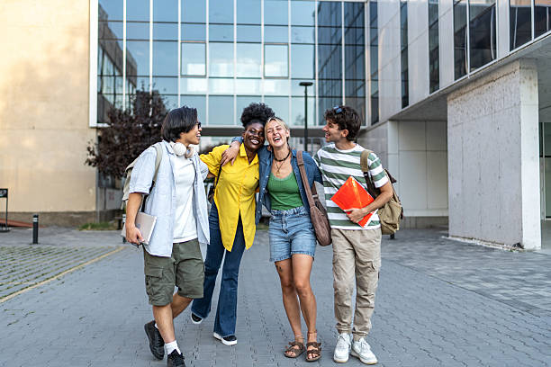 istock Diverse students laughing walking together on university campus 2248947825