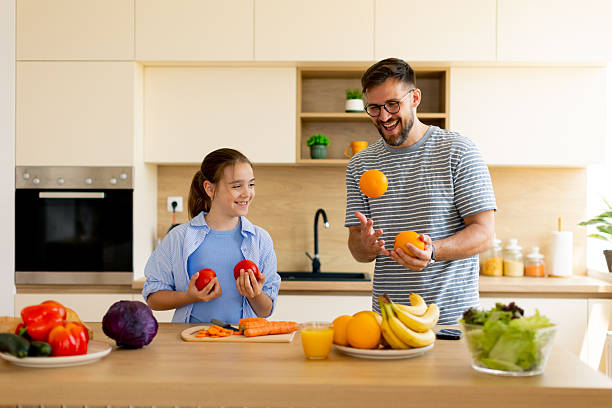 istock Joyful moments in a kitchen filled with fresh vegetables and fruits 2248952821