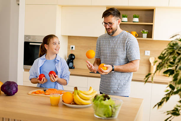 istock Father and daughter enjoy a fun cooking session in their modern kitchen 2248952828