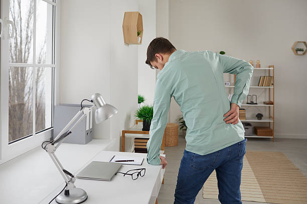 istock Rear view young man suffering from backache in ofiice 2248954762