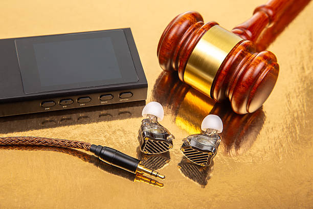 istock Legal tools and technology combined on a reflective surface with audio equipment 2248954944