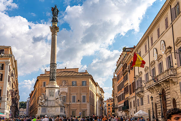 Rome, Italy; October 18, 2025: Tourists are visiting Column of the Immaculate Conception in the Piazza di Spagna, Rome, Italy.