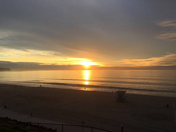 istock Stunning Sunset Over the Tranquil Beach With Gentle Waves and a Peaceful Atmosphere in the Early Evening Sky 2248962101