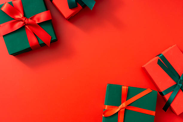 istock Christmas composition. Christmas gift boxes with bows on red background. 2248967013