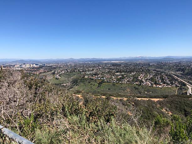 istock Sunny Day View From the Hillside Overlooking a Vibrant Cityscape and Distant Mountains During Midday 2248970280