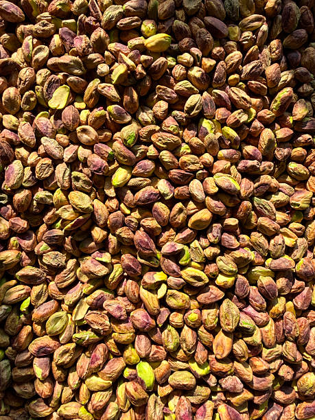 Image of raw pistachios roasting on an oven tray, healthy eating concept, natural high-protein snack, nutritious plant-based protein source