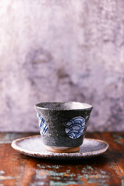 Traditional, handcrafted ceramic on wooden background. Soft focus. Close up.