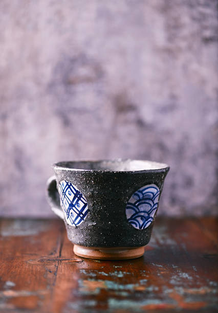 Traditional, handcrafted ceramic on wooden background. Soft focus. Close up.