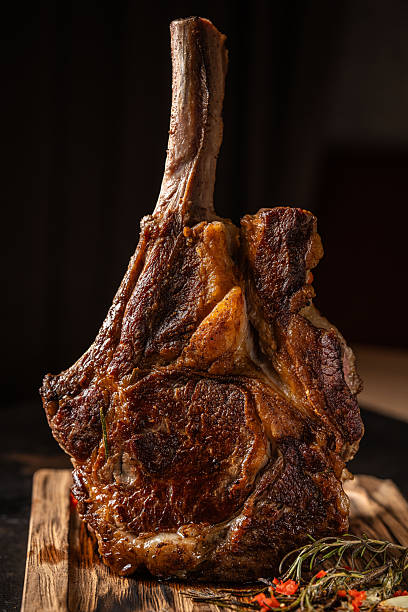 istock Tomahawk ribeye steak on wooden board. 2248975036