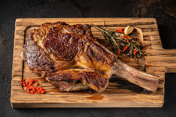 istock Grilled ribeye steak with bone on wooden board. 2248975047