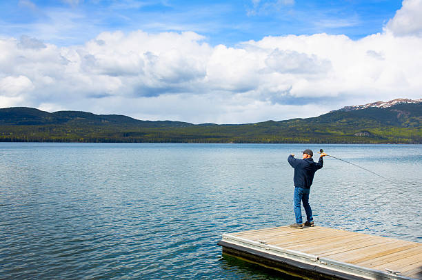 Canada British Columbia,  man at dock at Mucho lake. fishing