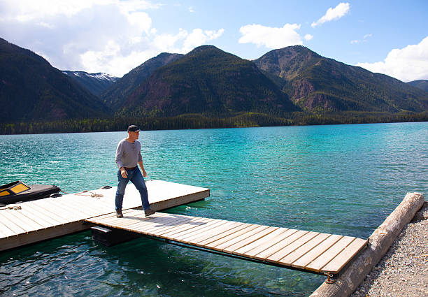 Canada British Columbia,  man at dock at Mucho lake.