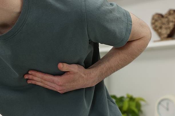 istock Man suffering from heart hurt at home, closeup 2248980558