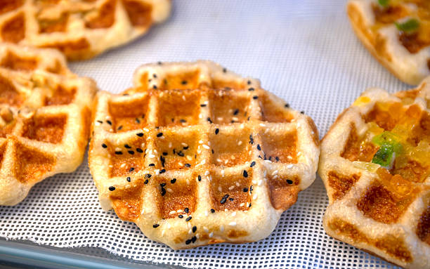 Waffle, Golden baked waffles on shelf, Waffle shop close-up, showcasing a crisp and appetizing texture. Perfect for food design, menus, and bakery advertising