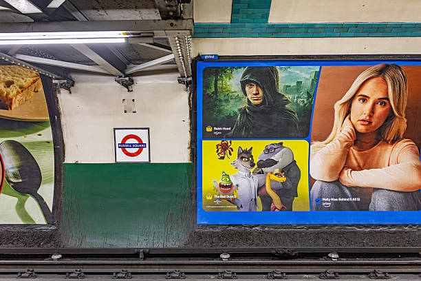 Russel Square, London, England, United Kingdom ,Europe - November 6th 2025: Colorful advertising posters displayed inside a London Underground station, highlighting their role as an integral part of the transport system’s economy. All stations across the English capital are richly decorated with commercial signage and promotional displays.