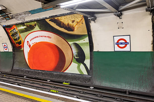 Russel Square, London, England, United Kingdom ,Europe - November 6th 2025: Colorful advertising posters displayed inside a London Underground station, highlighting their role as an integral part of the transport system’s economy. All stations across the English capital are richly decorated with commercial signage and promotional displays.