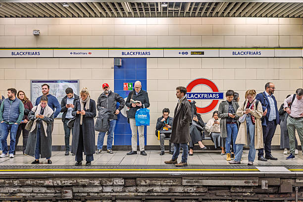 Blackfrias, London, England, United Kingdom ,Europe - November 5th 2025: Commuters standing on a platform during rush hour in the legendary London Underground, capturing the busy atmosphere of daily life in the English capital.