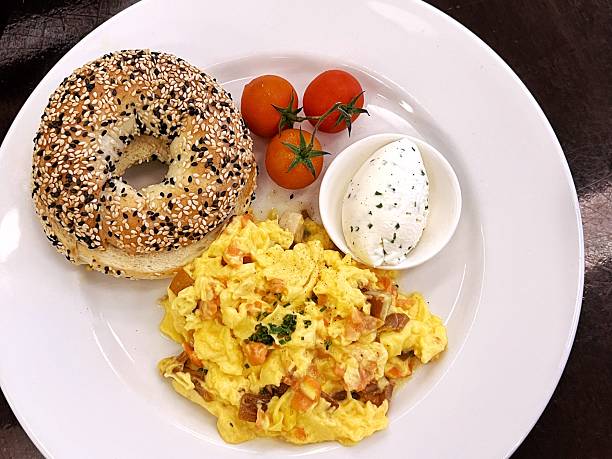 Bagel scrambled eggs and cherry tomatoes breakfast