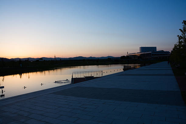 Dusk in city park with big pond