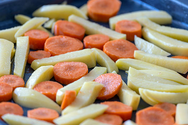 Potatoes and carrots ready to cook on a tray