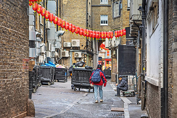 Chinatown, London, England, United Kingdom ,Europe - November 16th 2025: Urban backyard scene in London’s classic Chinatown, showing waste containers and air conditioning units. While the district has transformed in recent years into a fashionable area with popular restaurants, some hidden courtyards still evoke memories of its rough past.