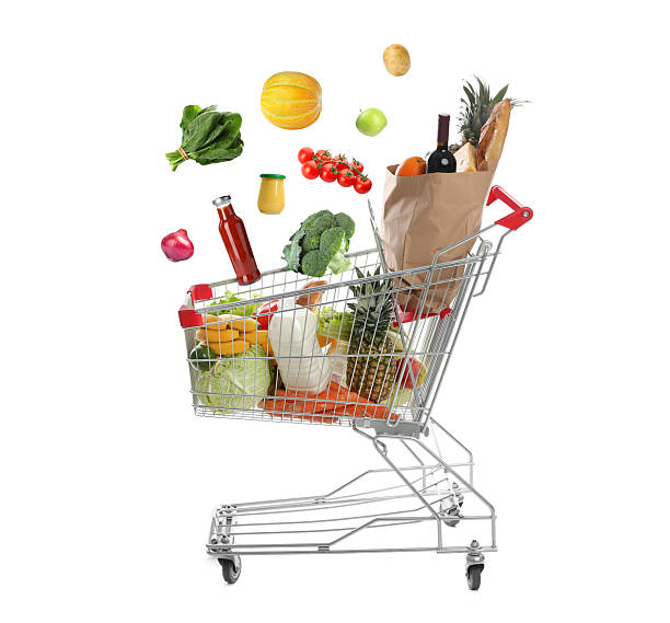 istock Groceries falling into shopping cart on white background 2248994140