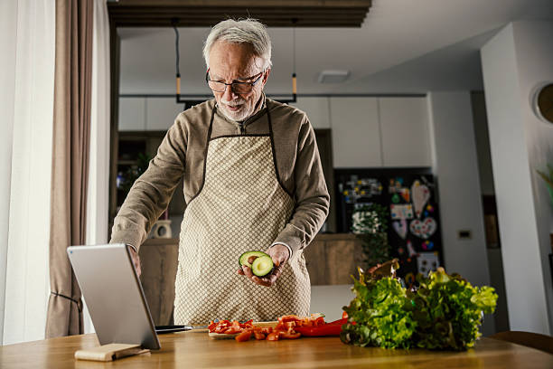 istock Senior man cooking healthy meal using digital tablet 2248995845