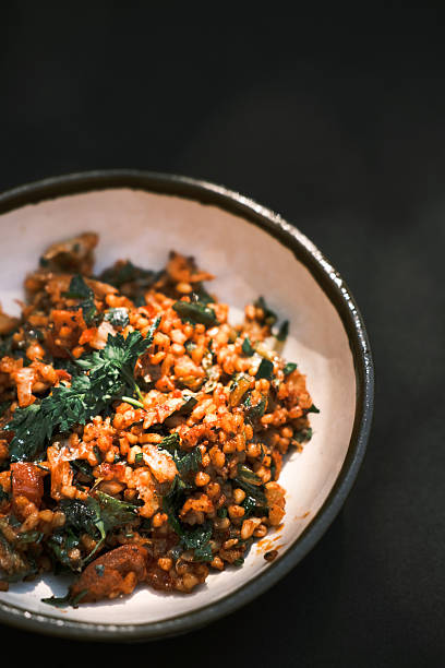 istock Top view of a traditional Turkish bulgur-based meze served in a ceramic bowl with herbs and vegetables, Mediterranean appetizer featuring rich colors and textures on dark background, Culinary culture concept for food menus and editorial visuals 2248997612