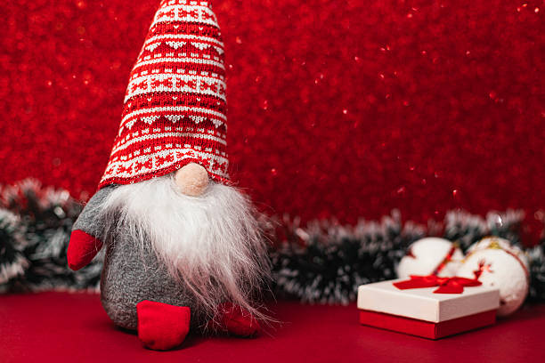 istock Plush Santa is sitting on a red background 2248999078