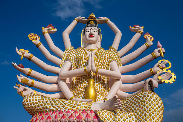 People praying in front of the multi armed shiva statue at Wenshu Temple, or Wenshu Monastery, a Buddhist temple located in Chengdu, Sichuan, China.