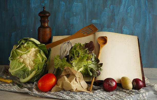vintage recipe or cook book with various vegetables and vintage kitchen utensils, cooking, menu food and drink concept.Free copy space