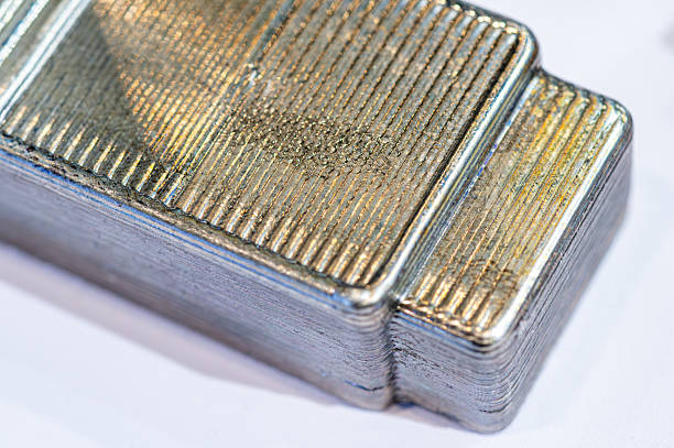Metal object produced by 3d printing technology, showing distinct layers and surface texture
