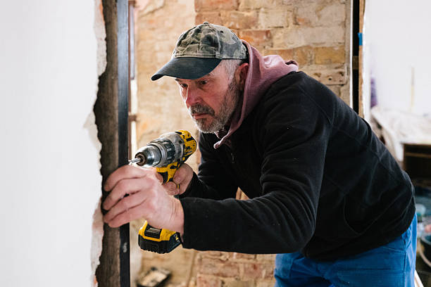 istock A bricklayer screws an iron girder into place for a new passageway 2249006141