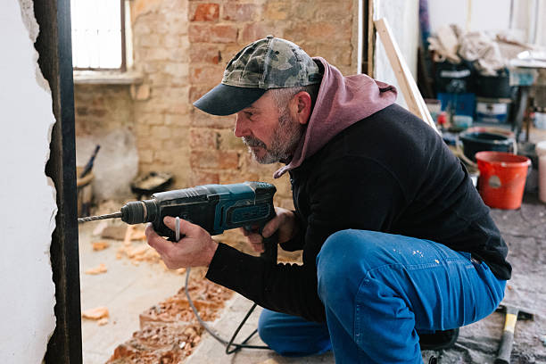 istock A bricklayer screws an iron girder into place for a new passageway 2249006150