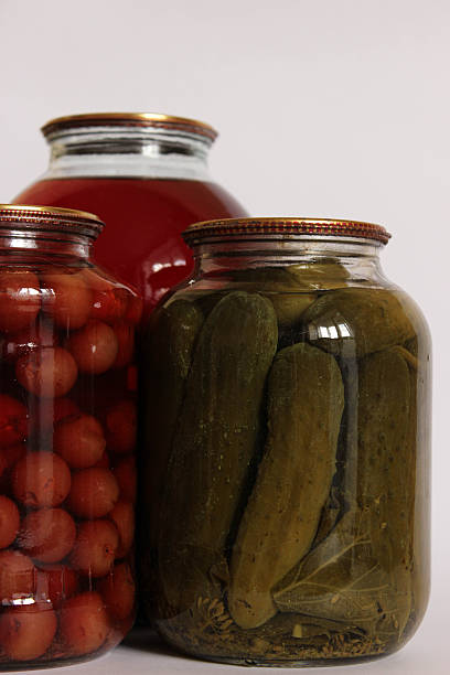 istock Three large glass jars. fruit compote, pickled cucumbers, and another compote on a white background. 2249006903