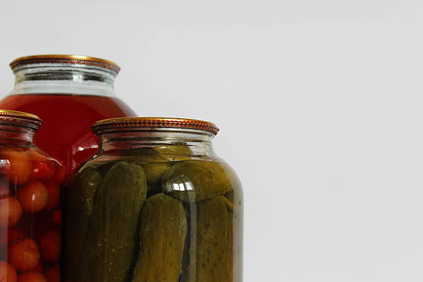 istock Three large glass jars. fruit compote, pickled cucumbers, and another compote on a white background. 2249006907