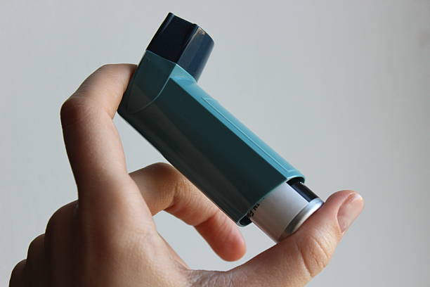 istock Blue Asthma Inhaler in Hand 2249007684