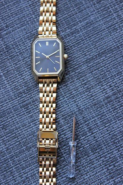 istock Vertical Shot of Gold Watch with Link Tool 2249008488