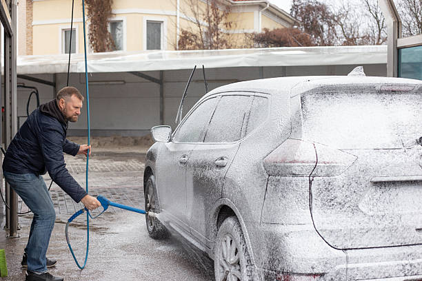 istock Man Washing Foam-Covered SUV at Self-Service Car Wash 2249010929