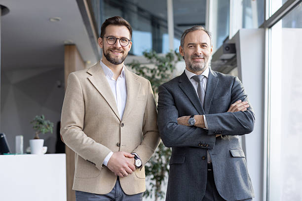 istock Two Businessmen Smiling Together in Modern Office 2249012449