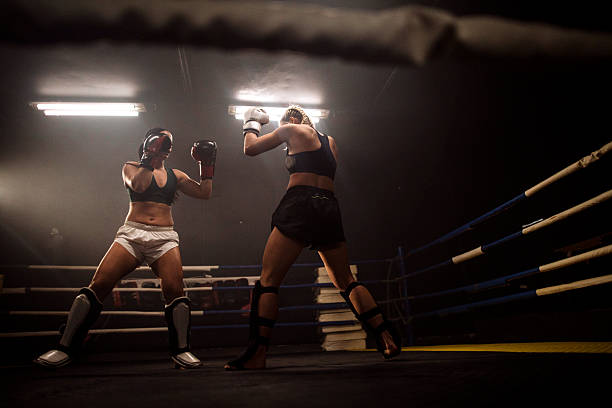 istock Two female boxers sparring in a boxing ring 2249016990