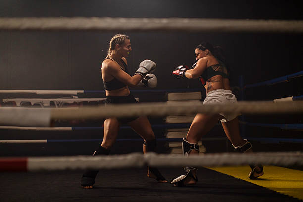 istock Two women boxing match in training ring arena 2249017926