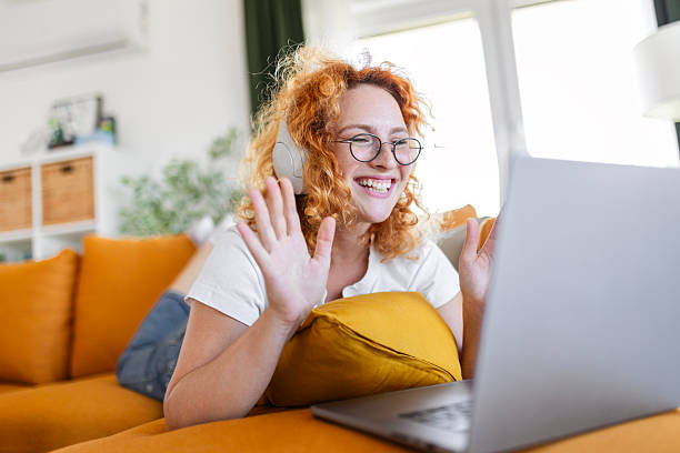 istock Casual Redhead Female Streaming Music While Using Laptop 2249018870