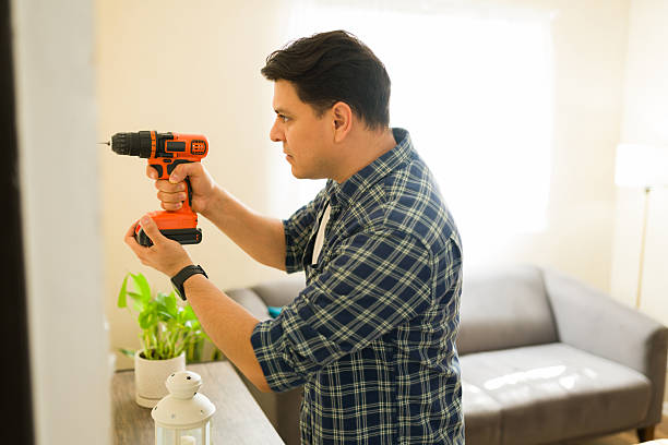 istock Person drilling hole in wall, doing home renovation at home, preparing for home decor installation 2249019484