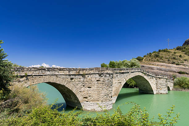 istock Graus stone bridge spanning green water in Aragon 2249019646