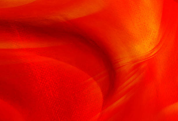 Vibrant red abstract fabric texture with flowing motion blur, warm orange gradient and soft wave-like folds. Evokes energy, warmth, modern design and tactile silk-like material ideal for backgrounds and creative projects.